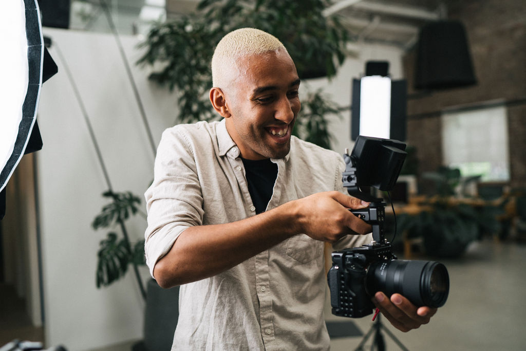 A videographer holding their camera while on set