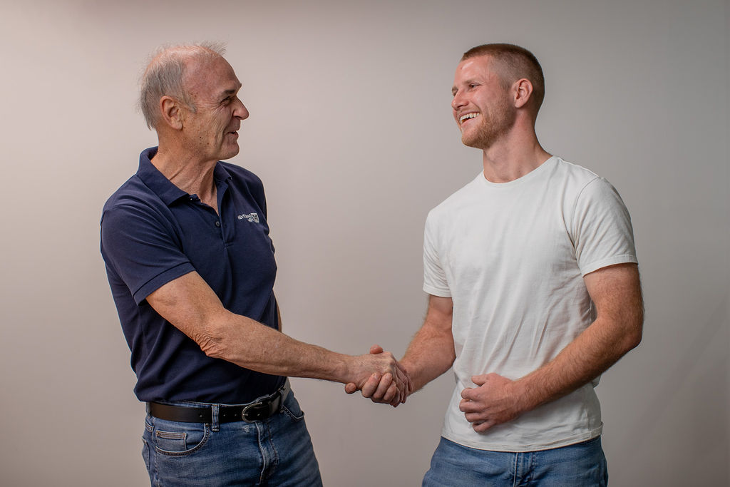 Alec and his Raise Foundation mentor shake hands